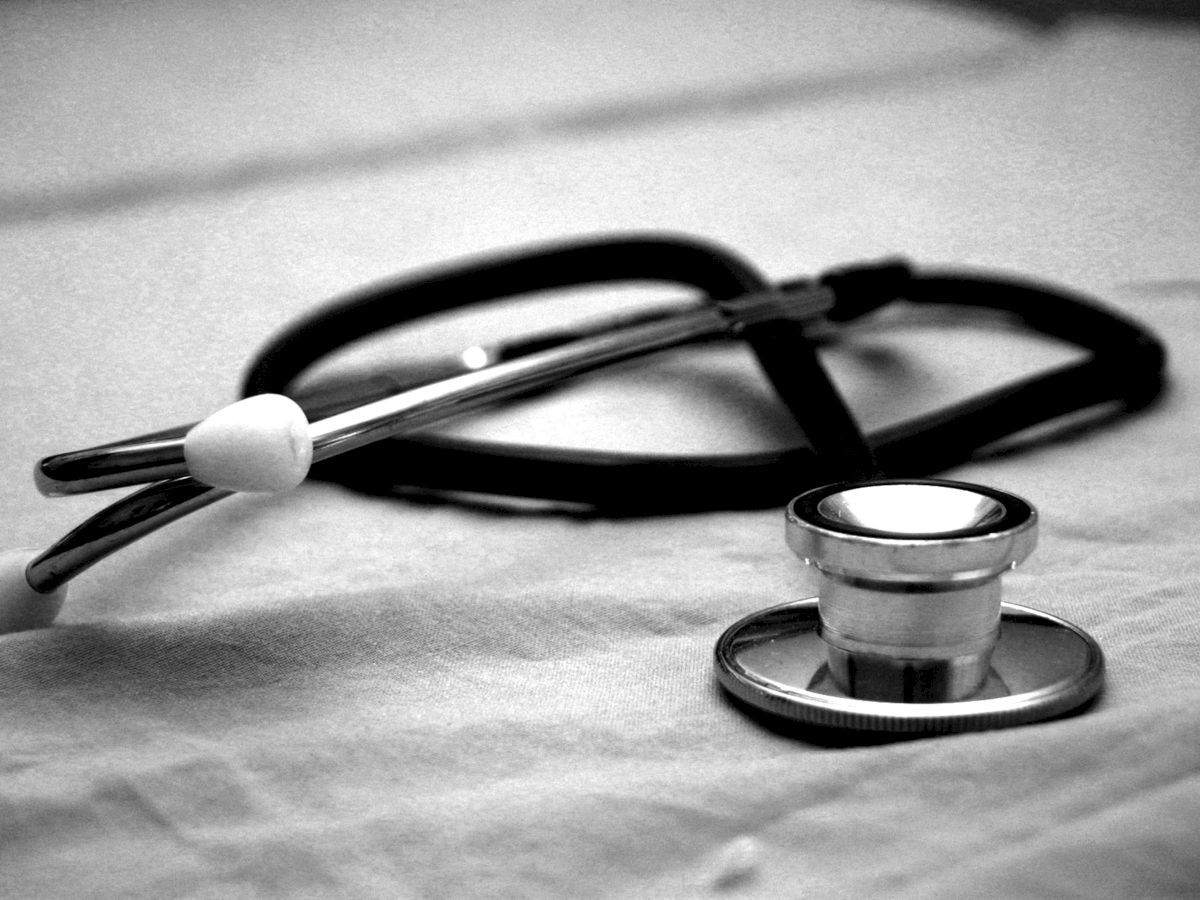 The image shows a stethoscope placed on a fabric surface, typically used for listening to heart and lung sounds.