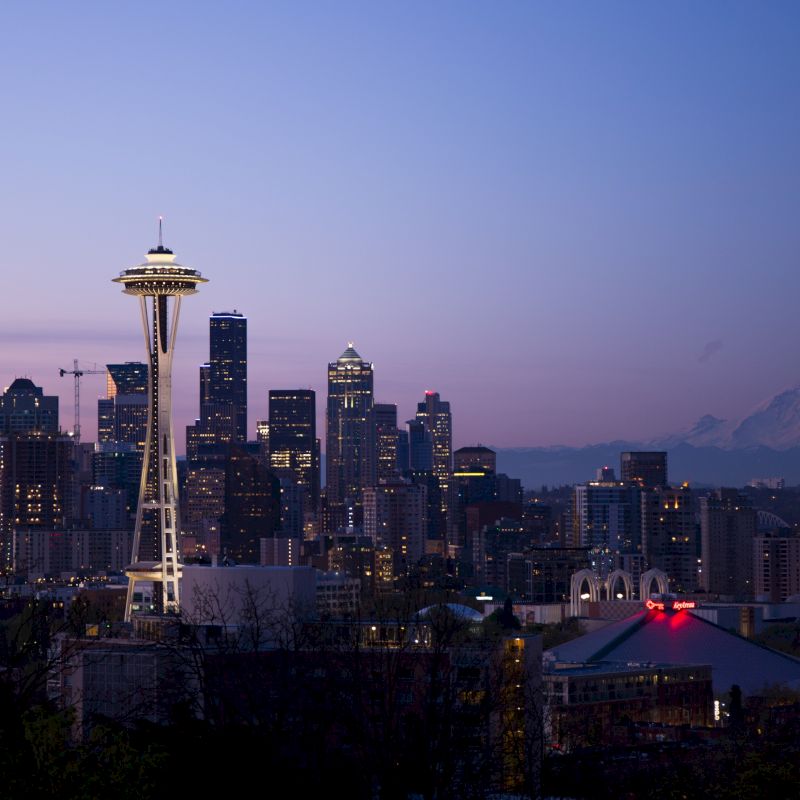 View of a cityscape during twilight with the Space Needle and Mt. Rainier in the background, Seattle, Washington.